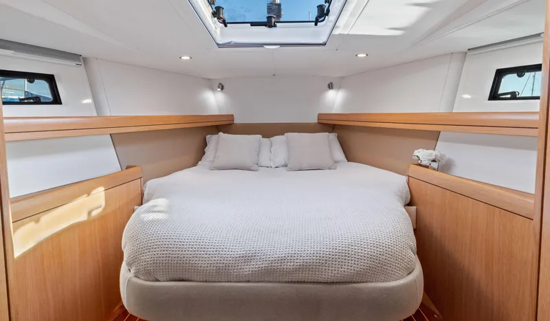 Margot Yacht Photos Pics Luxurious cabin interior of 2013 Oyster 575 yacht with skylight and cozy bedding.