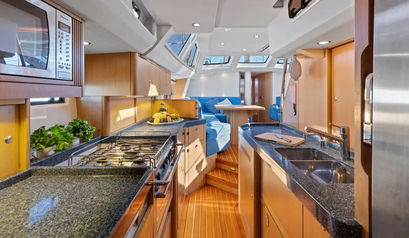 Margot Yacht Photos Pics Luxurious interior of 2013 Oyster 575 yacht with modern kitchen and dining area.