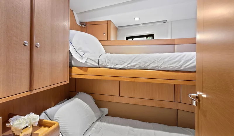 Margot Yacht Photos Pics Cozy cabin interior of 2013 Oyster 575 yacht with wooden bunk beds.