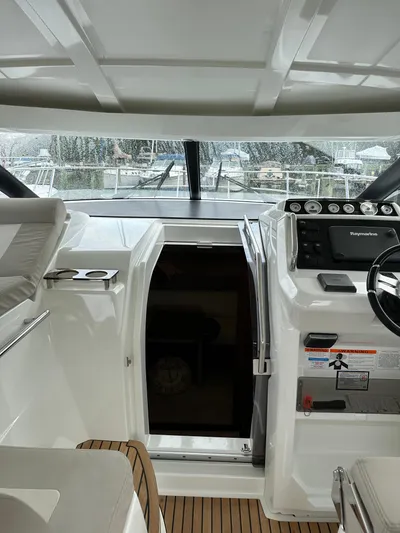 Small Batch Yacht Photos Pics 2016 Jeanneau Leader 36 cockpit with helm and cabin entrance.