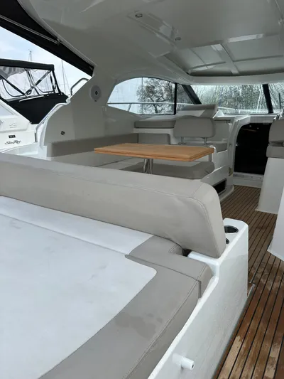 Small Batch Yacht Photos Pics 2016 Jeanneau Leader 36 interior with seating and wooden table.