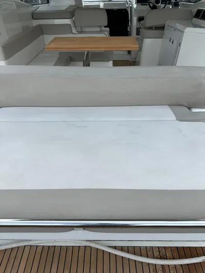 Small Batch Yacht Photos Pics 2016 Jeanneau Leader 36 boat interior with seating and wooden table.