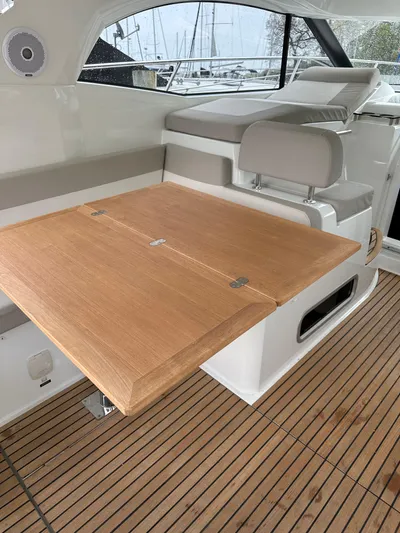 Small Batch Yacht Photos Pics 2016 Jeanneau Leader 36 interior with wooden table and seating.