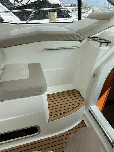 Small Batch Yacht Photos Pics 2016 Jeanneau Leader 36 interior seating area with wooden steps.