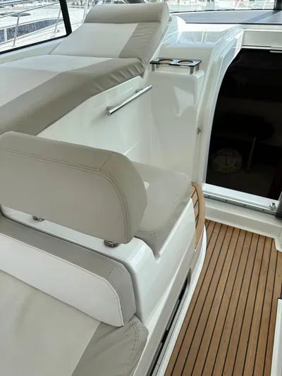Small Batch Yacht Photos Pics 2016 Jeanneau Leader 36 boat interior with cushioned seating and wooden flooring.