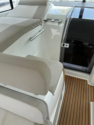 Small Batch Yacht Photos Pics 2016 Jeanneau Leader 36 interior with beige seating and wooden flooring.