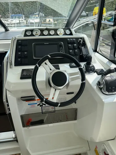 Small Batch Yacht Photos Pics 2016 Jeanneau Leader 36 helm station with steering wheel and navigation controls.