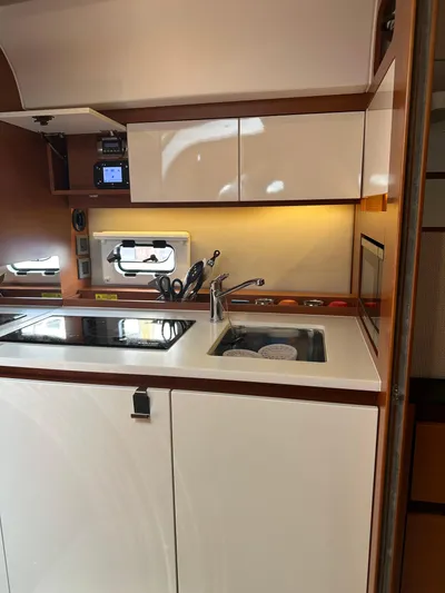 Small Batch Yacht Photos Pics Modern kitchen area in a 2016 Jeanneau Leader 36 yacht with sink and stove.