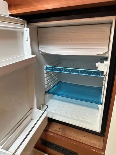 Small Batch Yacht Photos Pics Open refrigerator inside a 2016 Jeanneau Leader 36 boat.