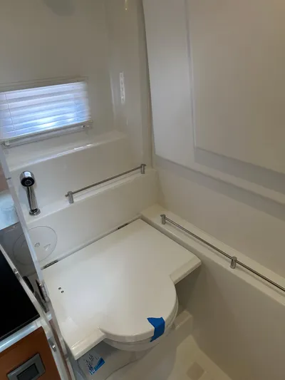 Small Batch Yacht Photos Pics 2016 Jeanneau Leader 36 bathroom with modern fixtures and compact design.