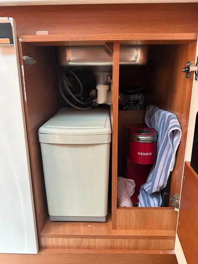 Small Batch Yacht Photos Pics Under-sink storage in 2016 Jeanneau Leader 36 boat with trash bin and Keurig coffee maker.