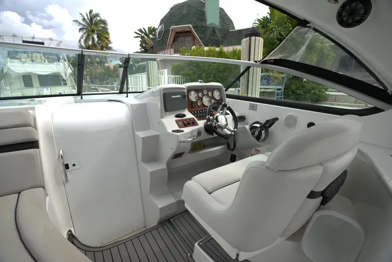  Yacht Photos Pics 2017 Rinker 320 Express Cruiser cockpit with modern controls and comfortable seating.
