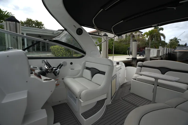  Yacht Photos Pics 2017 Rinker 320 Express Cruiser interior with sleek white seating and modern helm.