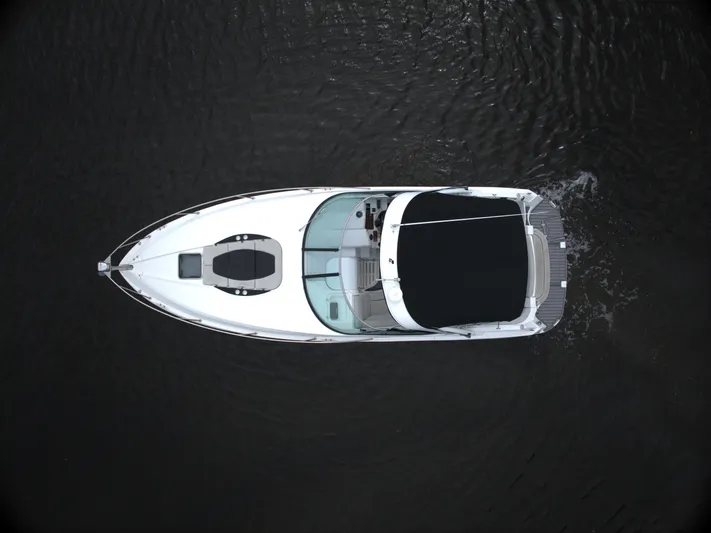  Yacht Photos Pics Aerial view of 2017 Rinker 320 Express Cruiser on dark water.