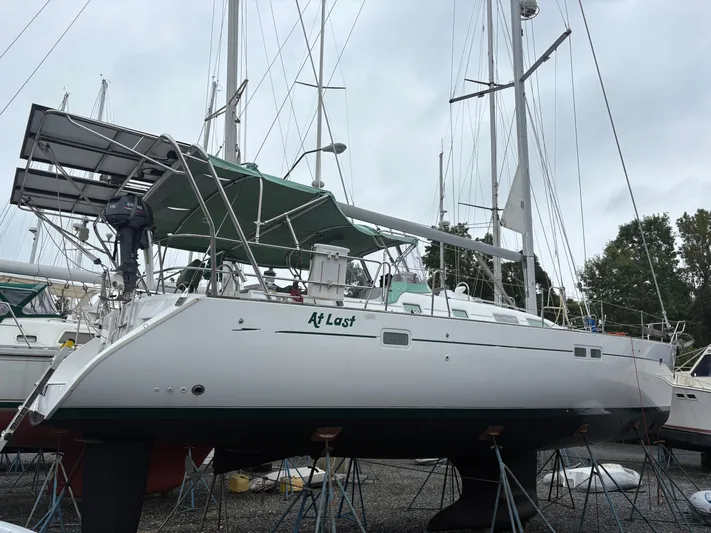 At Last Yacht Photos Pics 2004 Beneteau Oceanis 473 sailboat on stands, named "At Last," in a boatyard.