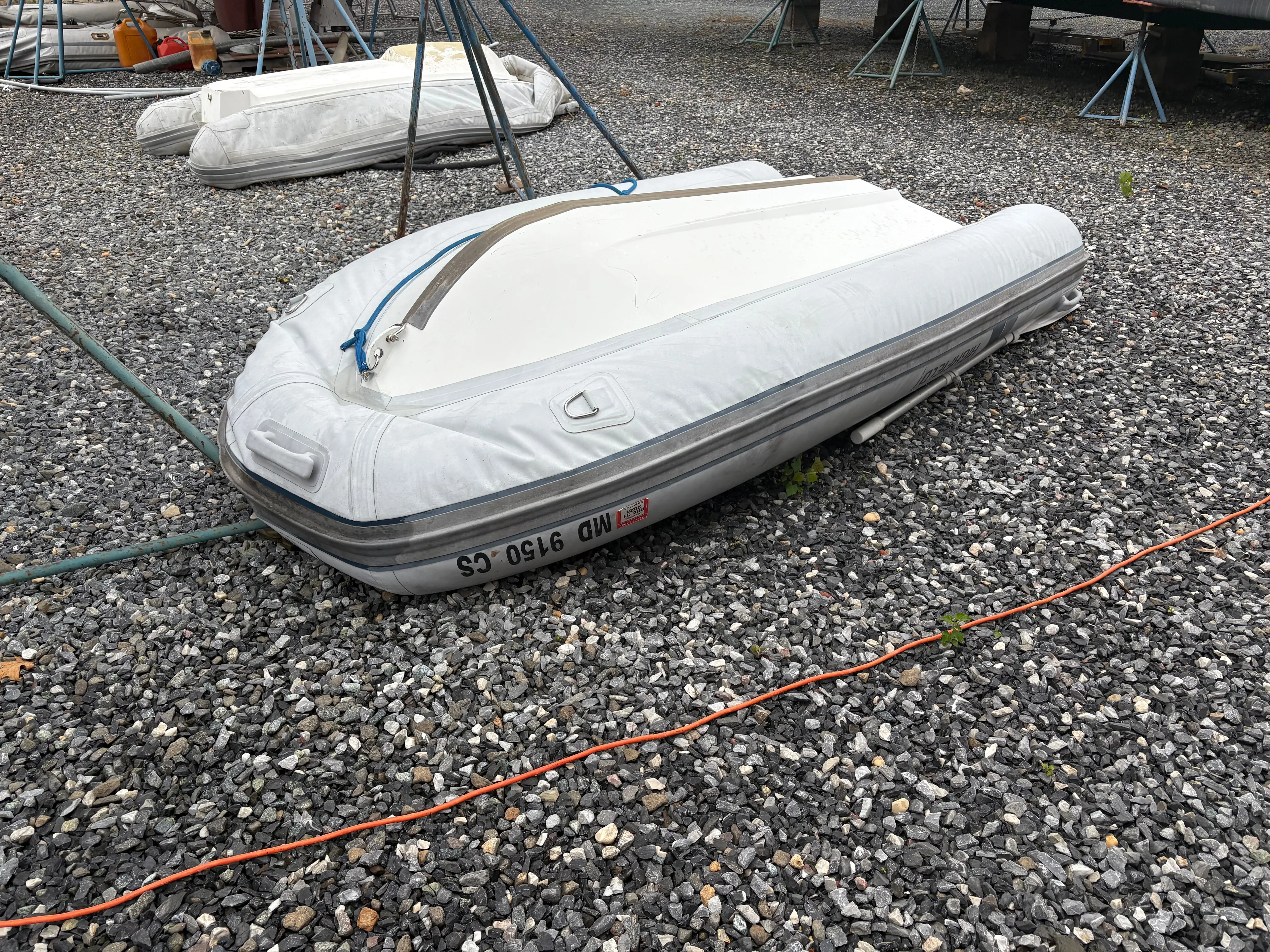 At Last Yacht Photos Pics Inflatable boat on gravel near Beneteau Oceanis 473, 2004 model.