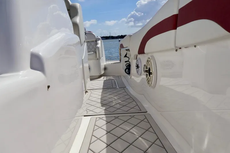  Yacht Photos Pics 2015 Deep Impact 33 boat deck with red accents and marine speaker.