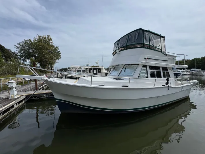 Eirene Yacht Photos Pics 2001 Mainship 390 yacht docked at marina, featuring spacious cabin and flybridge.