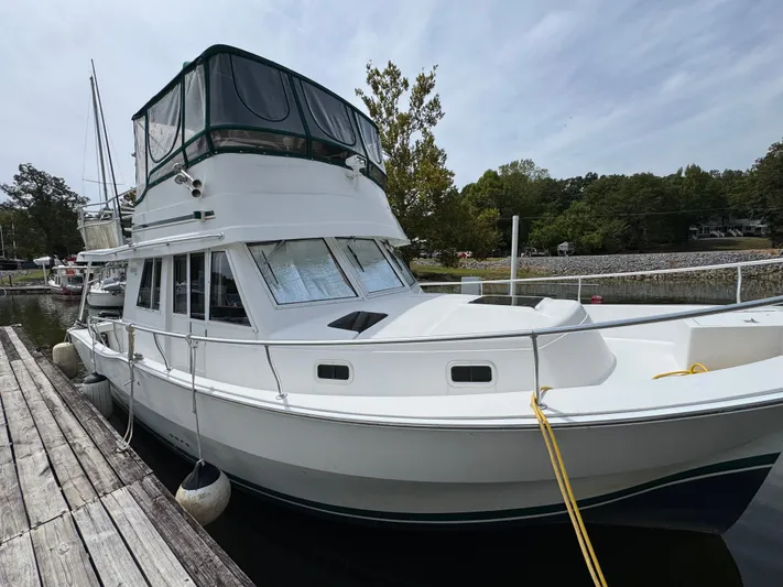 Eirene Yacht Photos Pics 2001 Mainship 390 yacht docked at a marina, featuring a spacious upper deck.