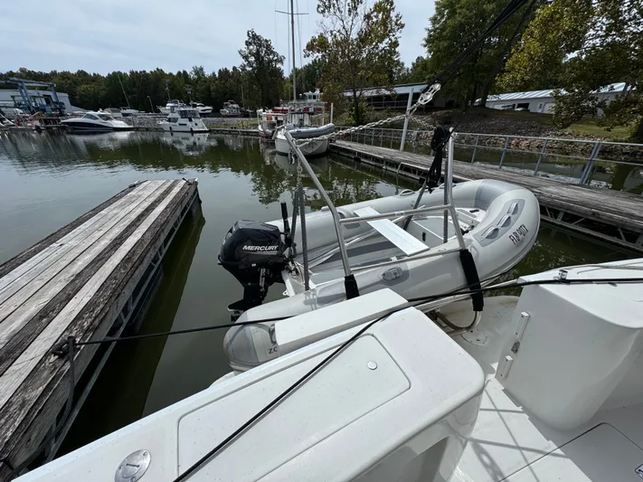 Eirene Yacht Photos Pics 2001 Mainship 390 docked with inflatable boat and Mercury outboard motor.