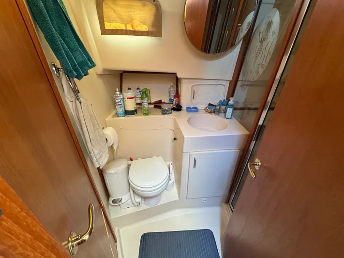Eirene Yacht Photos Pics Bathroom interior of 2001 Mainship 390 yacht, featuring sink, toilet, and storage.