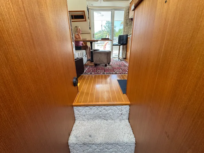 Eirene Yacht Photos Pics Interior view of 2001 Mainship 390 yacht with wooden flooring and seating area.