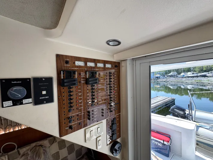 Eirene Yacht Photos Pics Control panel inside a 2001 Mainship 390 boat, overlooking a marina.