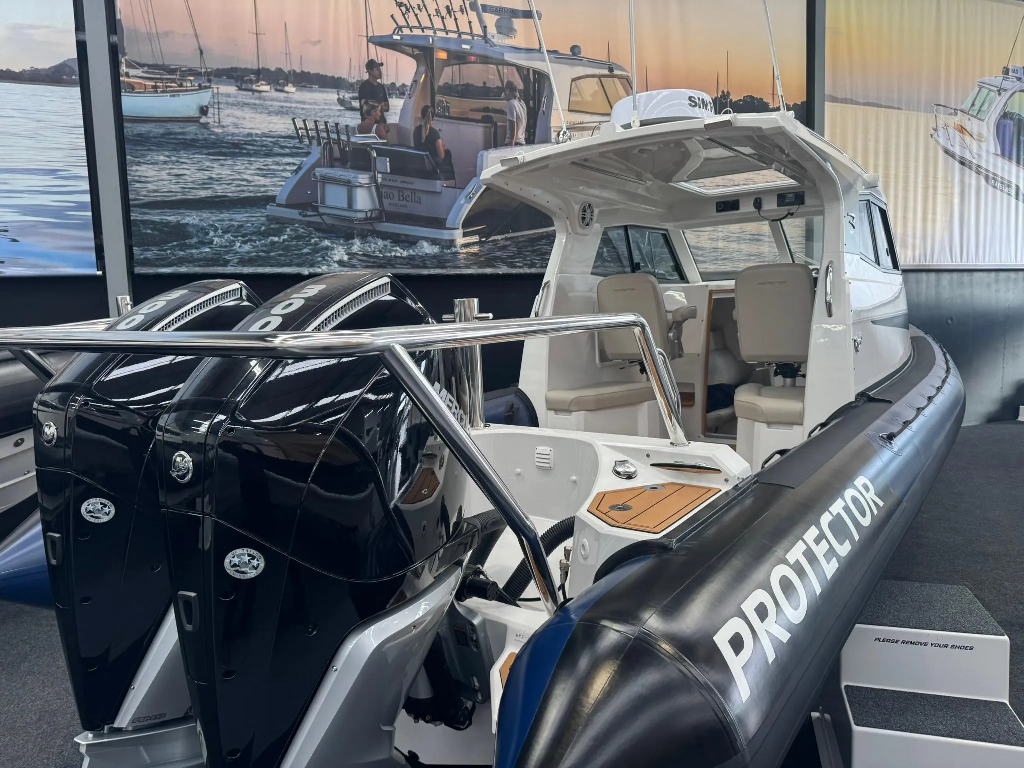 2025 Protector 310 Targa boat with dual V8 300 HP engines on display.