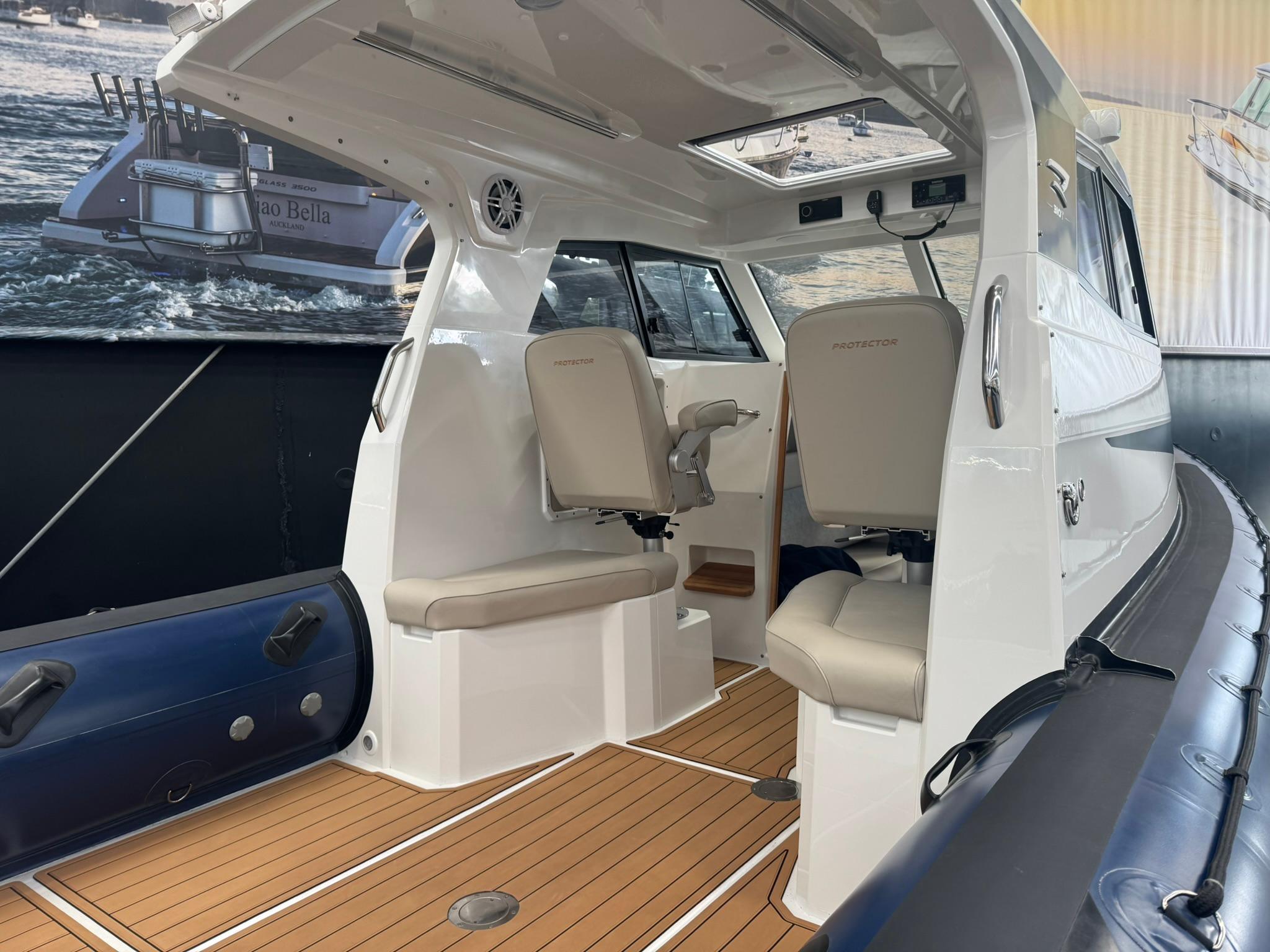 Interior of 2025 Protector 310 Targa boat with seating and modern design.
