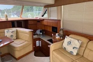  Yacht Photos Pics 2006 Silverton 42 Convertible yacht interior with beige seating and wooden cabinetry.