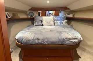  Yacht Photos Pics Cozy bedroom in 2006 Silverton 42 Convertible yacht with nautical-themed decor.