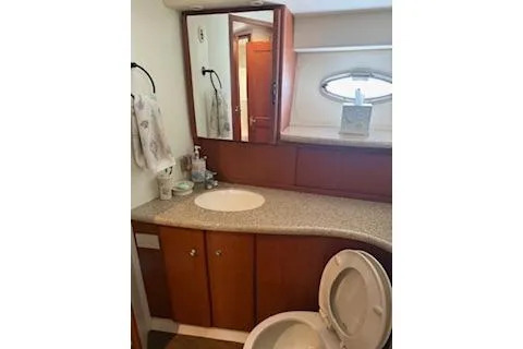  Yacht Photos Pics 2006 Silverton 42 Convertible yacht bathroom with wood cabinetry and oval window.