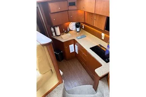  Yacht Photos Pics 2006 Silverton 42 Convertible yacht interior with modern kitchen and wooden cabinetry.