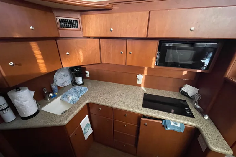  Yacht Photos Pics 2006 Silverton 42 Convertible yacht kitchen with wooden cabinets and modern appliances.