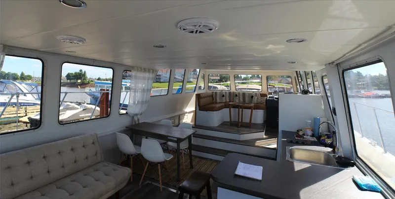 Imageneer Yacht Photos Pics Interior of 2015 Magna Marine 62 yacht with modern seating and large windows.