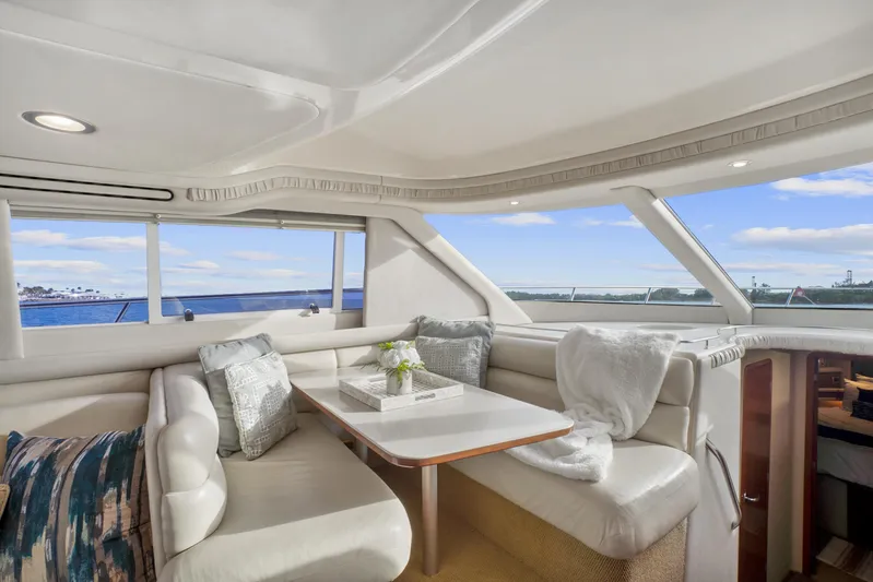 Our Trade Yacht Photos Pics Luxurious interior of 2001 Sea Ray 480 Sedan Bridge yacht with elegant seating and ocean view.