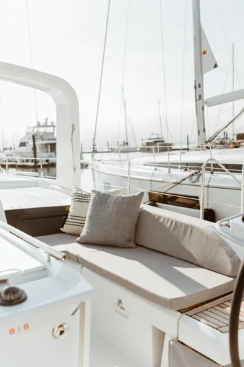  Yacht Photos Pics 2024 Beneteau Oceanis 46.1 yacht with elegant deck seating and marina view.