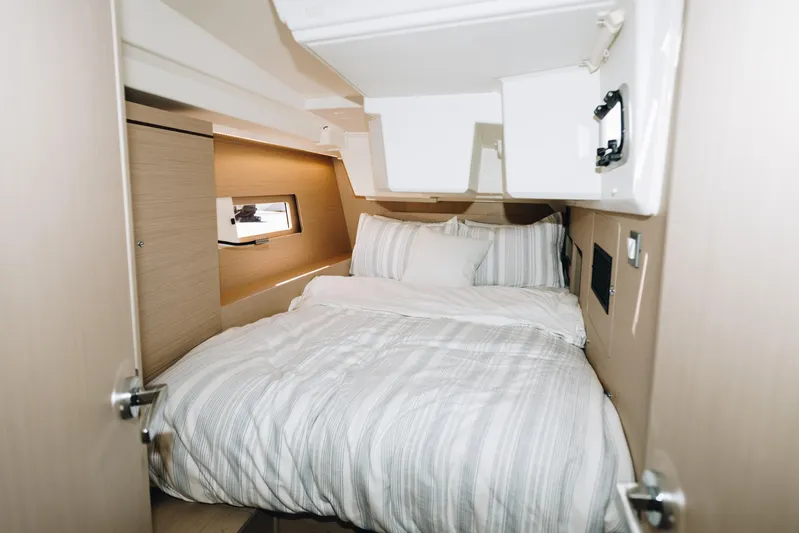  Yacht Photos Pics 2024 Beneteau Oceanis 46.1 cabin interior with cozy bed and modern design.