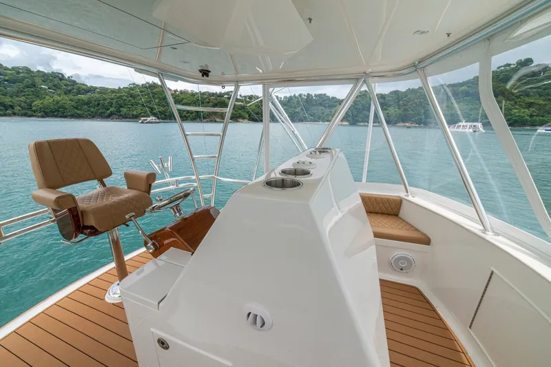 Annie Girl Yacht Photos Pics Custom Carolina 49 Ricky Gillikan 1997 yacht interior with helm and seating, overlooking serene waters.