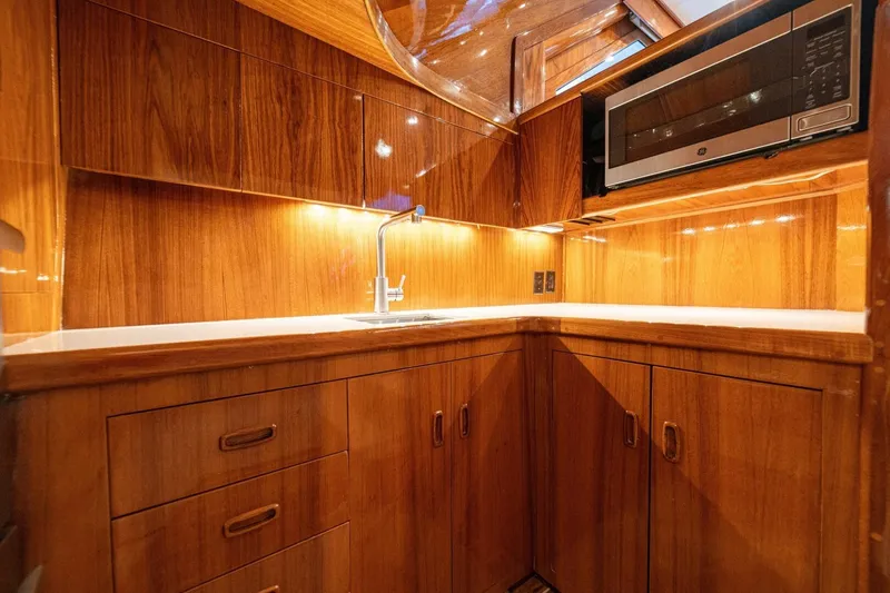 Annie Girl Yacht Photos Pics Luxurious wooden kitchen interior of 1997 Custom Carolina 49 Ricky Gillikan yacht.