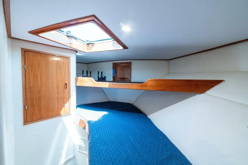 Annie Girl Yacht Photos Pics Interior of 1997 Custom Carolina 49 Ricky Gillikan boat with wooden accents and blue bedding.