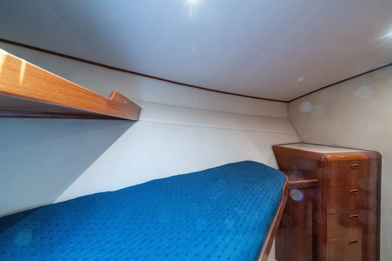 Annie Girl Yacht Photos Pics Cozy cabin interior of 1997 Custom Carolina 49 Ricky Gillikan with blue bedding and wooden furniture.