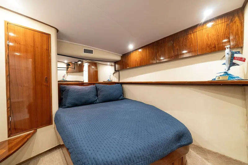 Annie Girl Yacht Photos Pics Luxurious cabin interior of 1997 Custom Carolina 49 Ricky Gillikan yacht with blue bedding.