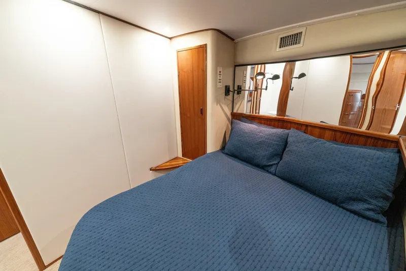 Annie Girl Yacht Photos Pics Cozy bedroom interior of 1997 Custom Carolina 49 Ricky Gillikan yacht with blue bedding.