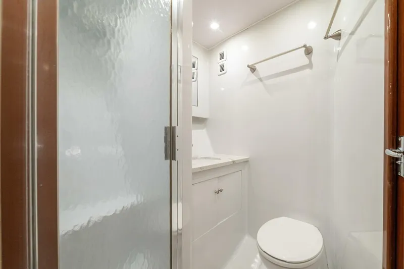 Annie Girl Yacht Photos Pics Bathroom interior of 1997 Custom Carolina 49 Ricky Gillikan yacht, featuring shower and toilet.