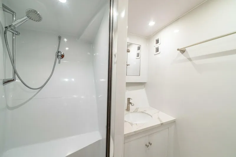 Annie Girl Yacht Photos Pics Luxurious bathroom in 1997 Custom Carolina 49 Ricky Gillikan yacht with modern shower and vanity.