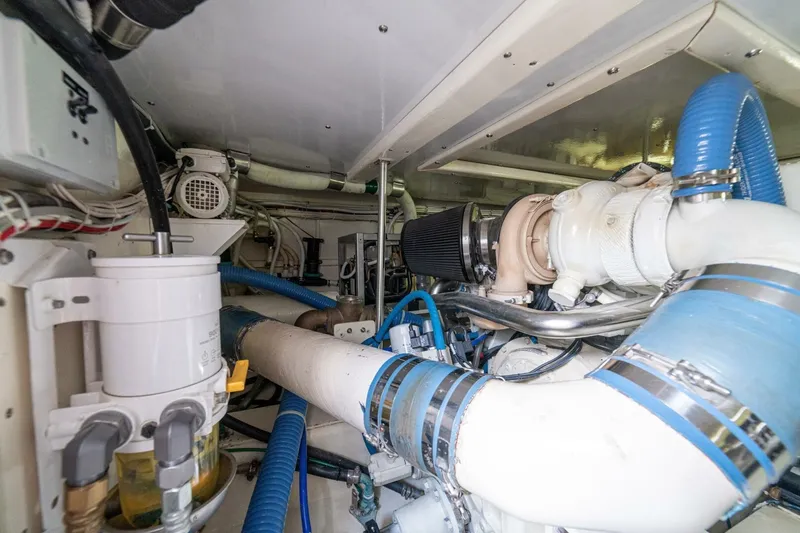 Annie Girl Yacht Photos Pics Engine room of 1997 Custom Carolina 49 Ricky Gillikan boat with blue hoses and machinery.