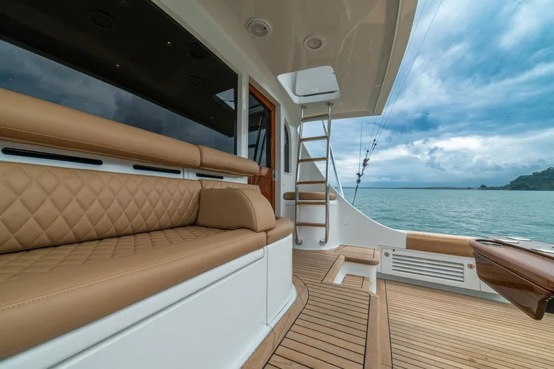 Annie Girl Yacht Photos Pics Luxurious interior of 1997 Custom Carolina 49 Ricky Gillikan yacht with tan seating and ocean view.