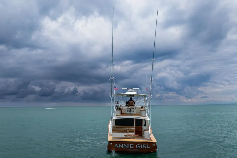 Annie Girl Yacht Photos Pics Custom Carolina 49 Ricky Gillikan boat on open sea under dramatic cloudy sky, 1997 model.