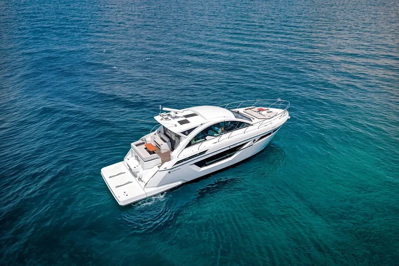 Duke Yacht Photos Pics 2018 Cruisers Yachts 50 Cantius on clear blue water, aerial view.